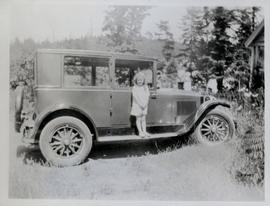 Muriel Bourne standing on running board of car on Arcadia Street