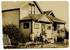 Cook family in front of their home at 525-527 Nelson Street