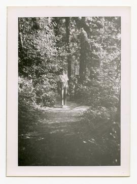 Emily Harrop standing on a path in a forest