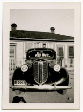 Arthur Harrop in a car parked in front of house