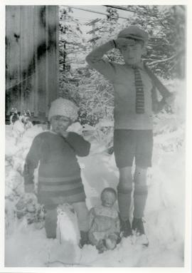Millicent and Sam Hughes in snow behind 891 Esquimalt Road