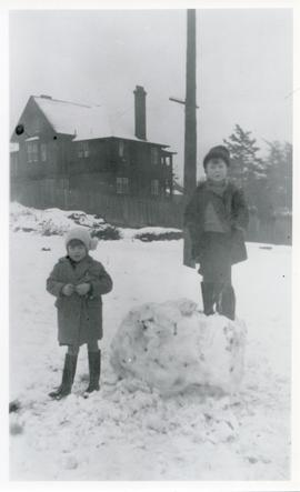 Millicent Hughes and Norman Dunnett playing in snow