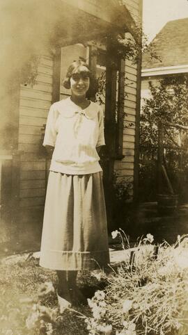 Girl in front of house