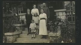 Sydney W. J. Feltham and family on steps of house