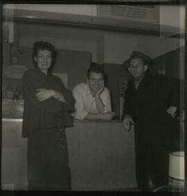 Three individuals in building interior.