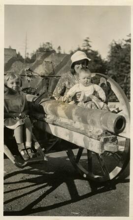 Women and children seated on guns at Memorial Park