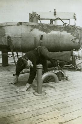 Sailor kneeling in front of a paravane