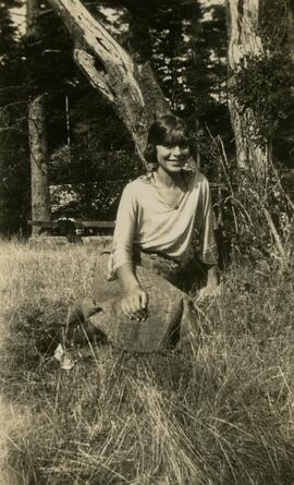 Woman seated under tree