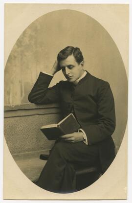 Studio portrait of a man reading a book