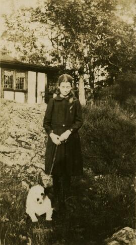 Girl with dog in garden