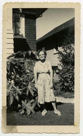 Woman standing in front of house