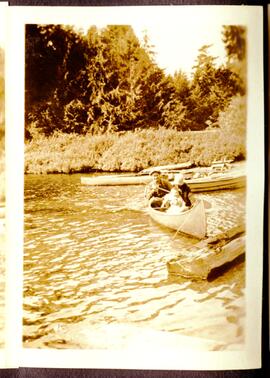 People in canoe with baby