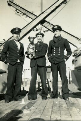 Three sailors with dog