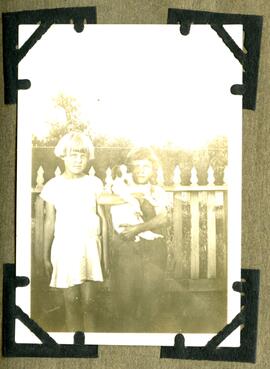Two young girls holding a puppy
