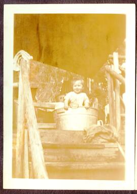 Baby in metal wash basin