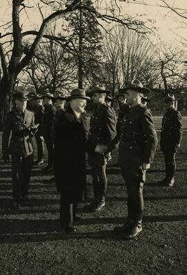 B.C. Provincial Police officers on grounds of Christ Church Cathedral, shaking hands with Attorney General of BC, Gordon Wismer