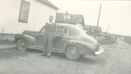 Eric Hall standing by 1940 Chevrolet