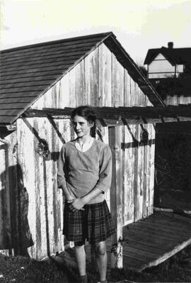 Rita Astbury [?] in front of boat house at foot of Kinver St.