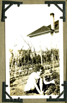 Girl kneeling in garden