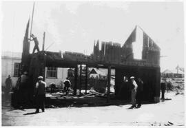 Dismantling old shed, new firehall in background
