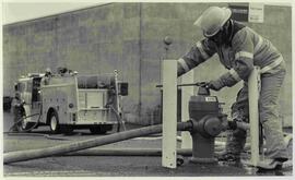 Sgt Derek Reid opening a hydrant