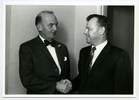 Dr. John Rogers and Mayor Art Young shaking hands on election night ...