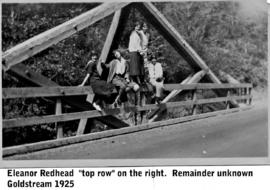 Youths sitting on bridge railing in Goldstream; Eleanor Redhead standing on right
