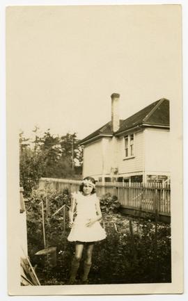 Young girl standing in a garden