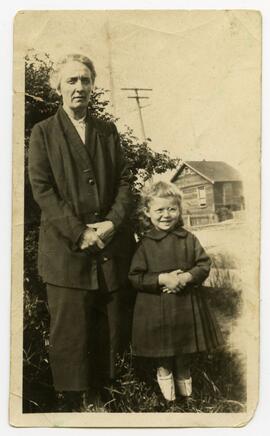 Woman and young child standing outside