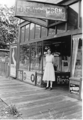 Margaret Hughes in front of Hughes Family Store ca. 1930