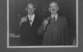 Two men in suits holding drinks