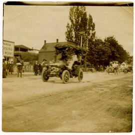 Decorated automobile driving down Fort Street