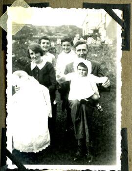Family group with baby wearing Christening gown