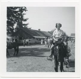 Young girl riding a horse