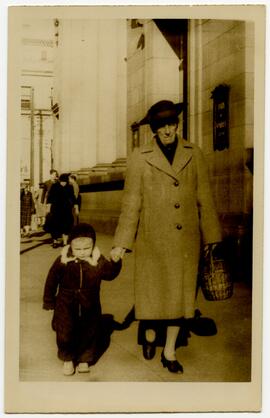 Sydney Spencer and child walking in downtown Victoria